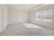 Bedroom featuring large windows, trey ceiling, and neutral colored carpet at 200 Haverling Pass, Hampton, GA 30228
