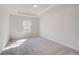 Cozy bedroom features plush carpet, natural light, and tray ceiling at 200 Haverling Pass, Hampton, GA 30228
