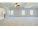 Bedroom with three windows, trey ceiling, and neutral colored carpet at 200 Haverling Pass, Hampton, GA 30228