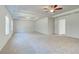Bedroom with neutral colored carpet, trey ceiling, and lots of windows at 200 Haverling Pass, Hampton, GA 30228