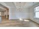 An elegant dining room featuring hardwood floors, wainscoting and a modern chandelier at 200 Haverling Pass, Hampton, GA 30228