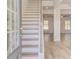 Bright entryway with hardwood floors, staircase, and views into living spaces at 200 Haverling Pass, Hampton, GA 30228