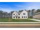 Two-story home featuring a brick facade, gabled roof, and manicured front yard at 200 Haverling Pass, Hampton, GA 30228