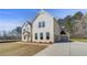 Two-story home with brick facade, attached garage, and long driveway at 200 Haverling Pass, Hampton, GA 30228