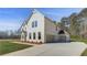A two-story home featuring a brick facade, attached garage, and large driveway at 200 Haverling Pass, Hampton, GA 30228