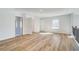 Open hallway boasts hardwood floors, plenty of natural light, and neutral walls at 200 Haverling Pass, Hampton, GA 30228