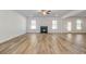Spacious living room featuring hardwood floors, a fireplace, and natural light from large windows at 200 Haverling Pass, Hampton, GA 30228