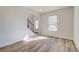 Bright living room with hardwood floors, staircase, and natural light from the window at 200 Haverling Pass, Hampton, GA 30228