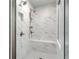 Luxurious shower with a rainfall showerhead, built-in bench, and marble tile surround at 200 Haverling Pass, Hampton, GA 30228
