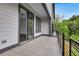 A covered balcony offers a serene escape with views of the surrounding lush greenery and trees at 587 Red Clay Farm Ln, Suwanee, GA 30024