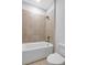 Full bath features a tub with tiled walls at 587 Red Clay Farm Ln, Suwanee, GA 30024