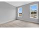 Bright bedroom with two windows and neutral carpet at 587 Red Clay Farm Ln, Suwanee, GA 30024