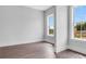 An airy bedroom with two large windows offering a view of a green landscape at 587 Red Clay Farm Ln, Suwanee, GA 30024