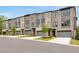 Row of new townhomes with brick facade, garages, and attractive landscaping at 587 Red Clay Farm Ln, Suwanee, GA 30024