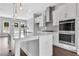 Modern white kitchen featuring island, stainless appliances, and pendant lighting at 587 Red Clay Farm Ln, Suwanee, GA 30024