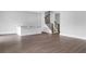 Bright living room with hardwood floors, wet bar, and staircase with black iron spindles at 587 Red Clay Farm Ln, Suwanee, GA 30024