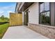 Patio of home with privacy fence, brick foundation, and natural setting in the background at 587 Red Clay Farm Ln, Suwanee, GA 30024