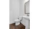 The powder room features modern fixtures and finishes at 587 Red Clay Farm Ln, Suwanee, GA 30024