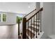 Staircase with dark wood treads and white risers at 587 Red Clay Farm Ln, Suwanee, GA 30024