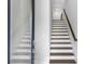 Modern staircase with wood treads, white risers, and minimalist design at 587 Red Clay Farm Ln, Suwanee, GA 30024