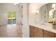 Bright bathroom featuring hardwood floors, a modern vanity, and a view of the backyard at 906 Fairfield Dr, Marietta, GA 30068