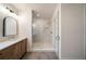 Modern bathroom featuring a glass shower with light tile, and a light-wood vanity with a sink at 906 Fairfield Dr, Marietta, GA 30068