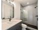 Modern bathroom featuring a glass shower, a dark vanity with a white countertop, and hexagon-tiled floors at 906 Fairfield Dr, Marietta, GA 30068