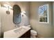 Elegant powder room with modern fixtures, a vanity, and a window with a view at 906 Fairfield Dr, Marietta, GA 30068