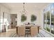 Elegant dining room with stylish chandelier, large windows, and hardwood floors at 906 Fairfield Dr, Marietta, GA 30068