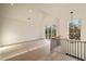 Open-concept living room with soaring ceilings, hardwood floors, and large windows for ample natural light at 906 Fairfield Dr, Marietta, GA 30068