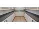 Spacious walk-in pantry featuring white cabinets and stone countertops under a round window at 906 Fairfield Dr, Marietta, GA 30068