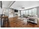 Cozy living room featuring a fireplace, hardwood floors, and large windows for ample natural light at 209 Enfield Ln, Mcdonough, GA 30252