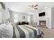 Cozy main bedroom featuring a brick fireplace, a TV, a large bed, and comfortable seating at 209 Enfield Ln, Mcdonough, GA 30252