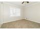 Bedroom features carpet floors, a ceiling fan, and a window with blinds at 4055 S Bogan Rd, Buford, GA 30519