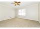 Comfortable bedroom featuring carpeted floors, neutral paint, a ceiling fan and lots of natural light at 4055 S Bogan Rd, Buford, GA 30519