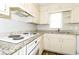 Efficient kitchen with granite counters, vinyl floors, white cabinets and modern appliances at 4055 S Bogan Rd, Buford, GA 30519