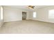 Bright living room featuring carpeted floors, neutral paint, a ceiling fan and lots of natural light at 4055 S Bogan Rd, Buford, GA 30519