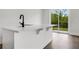 Bar top area with sink, slider to the backyard, and durable flooring at 557 Red Clay Farm Ln, Suwanee, GA 30024
