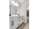 Bright bathroom with double sink vanity, quartz countertop, and modern fixtures at 557 Red Clay Farm Ln, Suwanee, GA 30024