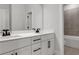 Bathroom with double sink vanity, quartz countertop, and view of the tub and shower at 557 Red Clay Farm Ln, Suwanee, GA 30024