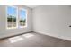Bedroom featuring two windows with a view of the outdoors and neutral carpet at 557 Red Clay Farm Ln, Suwanee, GA 30024