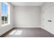 Bright bedroom with carpet, natural light from large window, and closet at 557 Red Clay Farm Ln, Suwanee, GA 30024