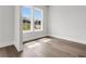 This is a bedroom with hardwood floors, a large window, and neutral paint, showing a bright and airy space at 557 Red Clay Farm Ln, Suwanee, GA 30024