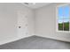 Bright bedroom featuring carpet, white walls, and a window with a view at 557 Red Clay Farm Ln, Suwanee, GA 30024