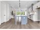 Well-lit kitchen with stainless steel appliances, a kitchen island and stylish pendant lighting at 557 Red Clay Farm Ln, Suwanee, GA 30024