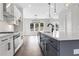 Contemporary kitchen featuring stainless steel appliances, white cabinets, and large kitchen island at 557 Red Clay Farm Ln, Suwanee, GA 30024