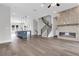 Spacious living area with tiled fireplace, hardwood flooring, and an open flow to the kitchen at 557 Red Clay Farm Ln, Suwanee, GA 30024