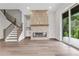 Stylish living area with modern fireplace, hardwood floors, and access to the outdoor balcony at 557 Red Clay Farm Ln, Suwanee, GA 30024