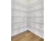 A pantry featuring white wire shelving and hardwood floors offer organized storage at 557 Red Clay Farm Ln, Suwanee, GA 30024