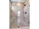 Walk-in shower with clear glass, seating, mosaic tile, and chrome fixtures at 557 Red Clay Farm Ln, Suwanee, GA 30024